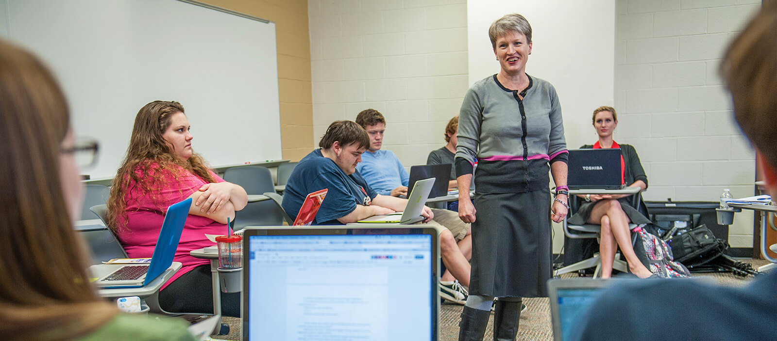 Professor MacDiarmid in front of a classroom of students.