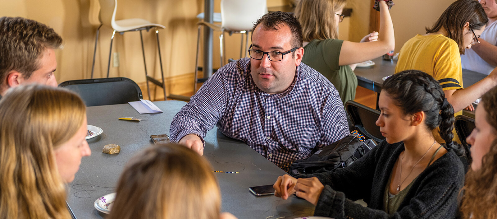 Professor Billy Korinko seated at a table with students