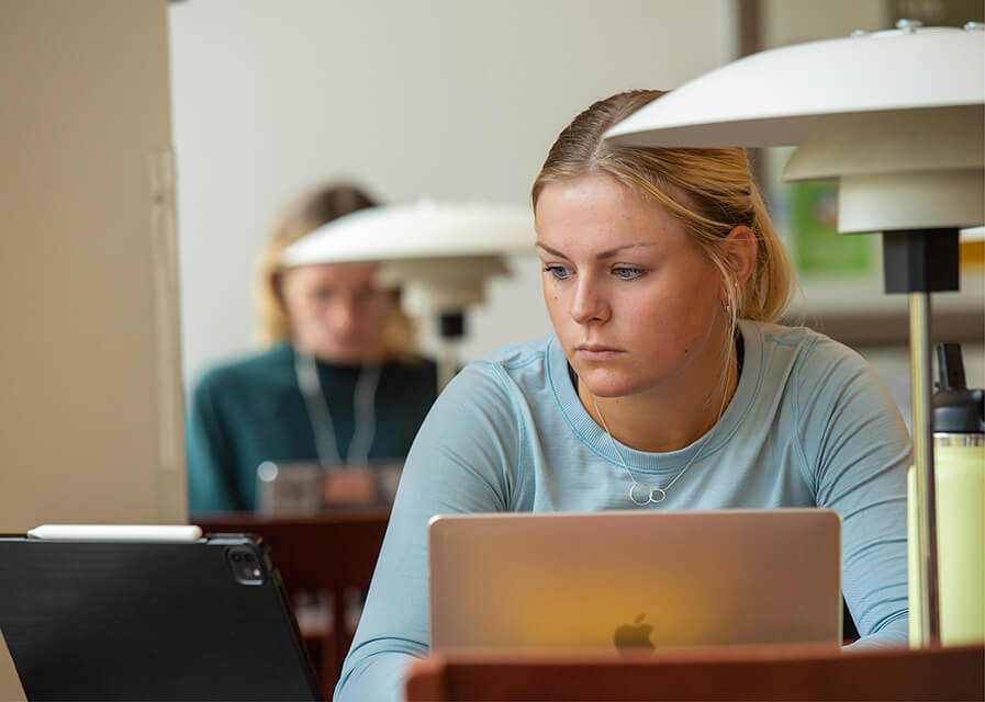 A student listens to an academic presentation in her class.