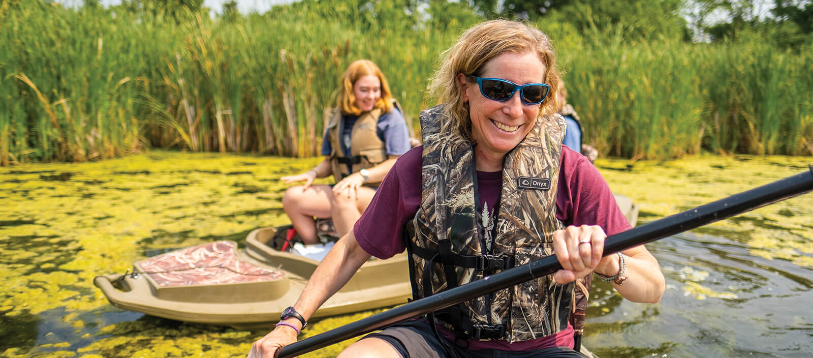 Professor Carrie Kissman and student in a row boat on a research expedition