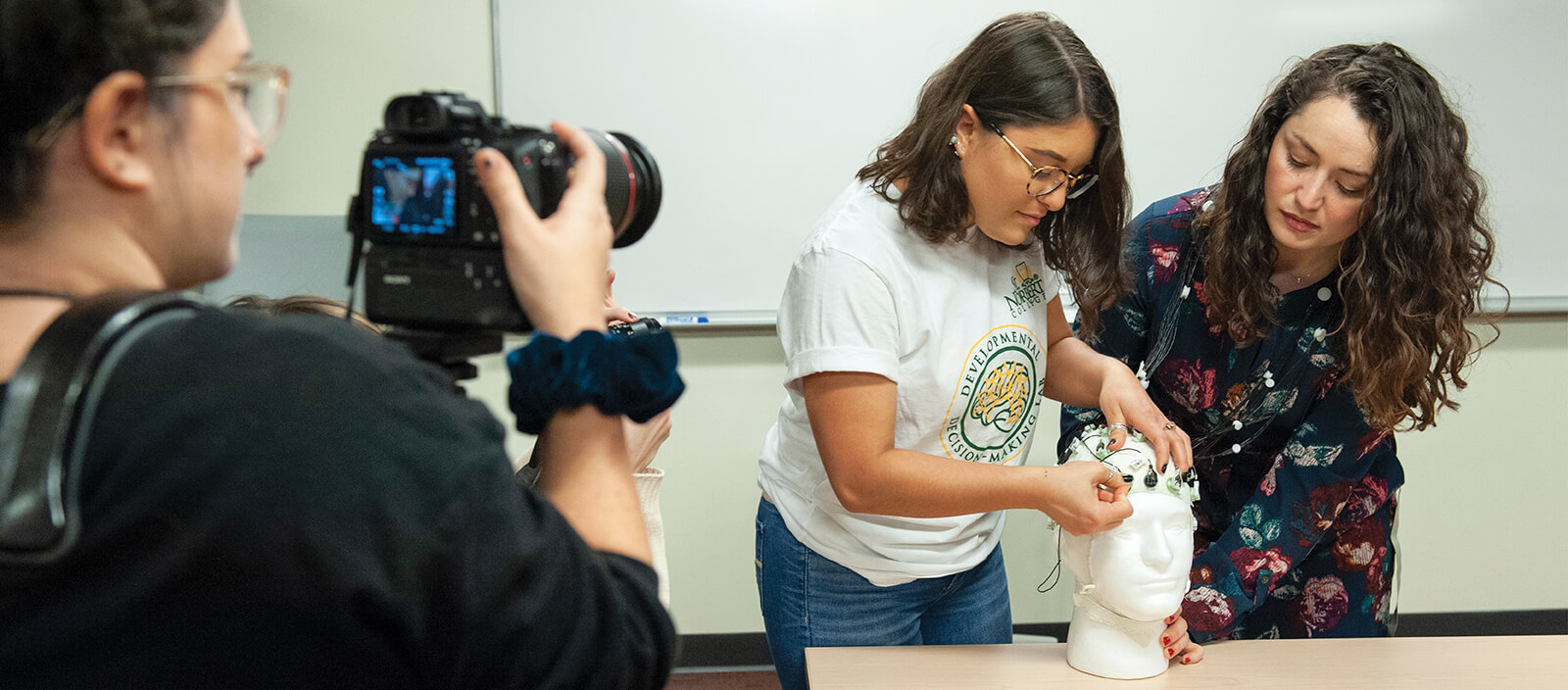 Professor guides student through an experiment. 