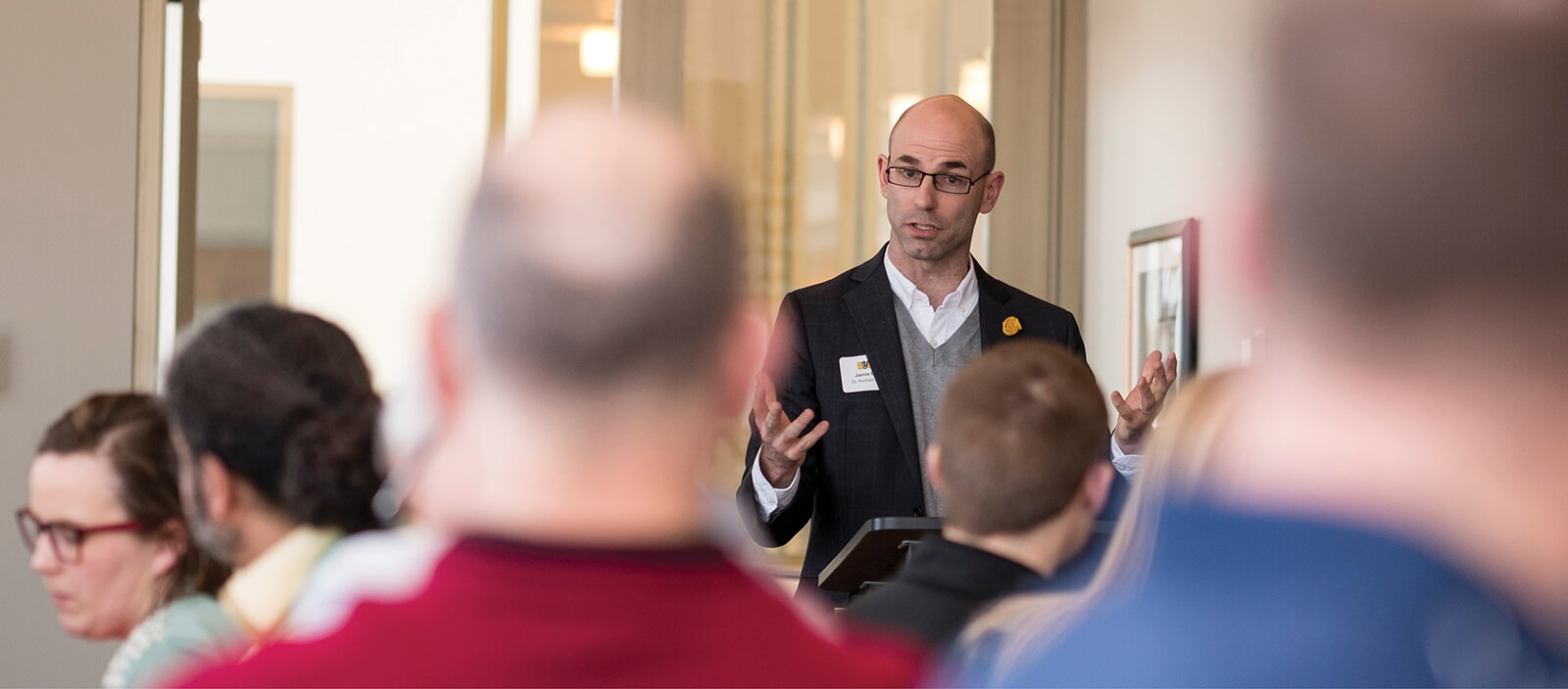 Young professional presents to a group of local leaders.