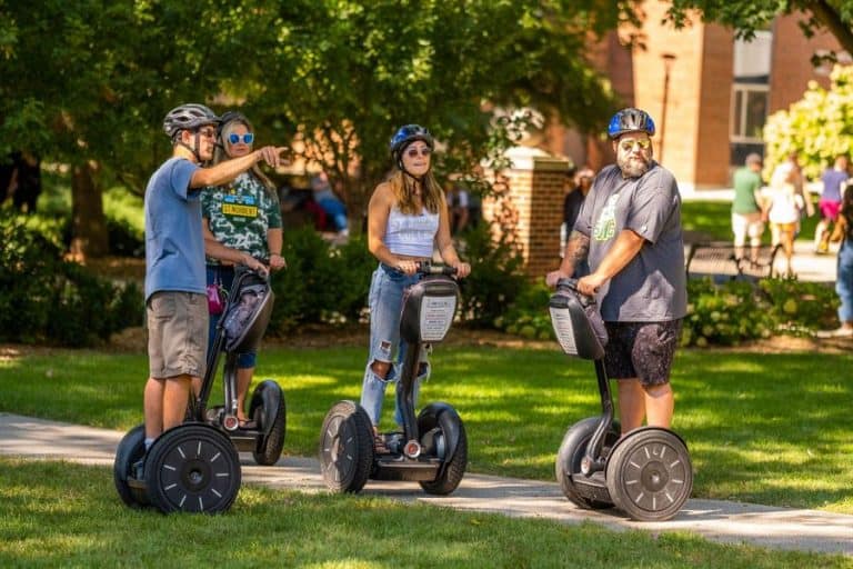 SNC Students exploring the campus on standing motorized vehicles